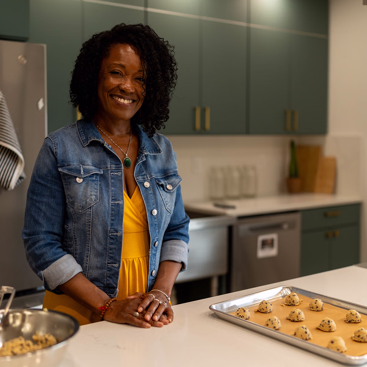 Hope Seavers smiling at kitchen counter with unbaked cookies