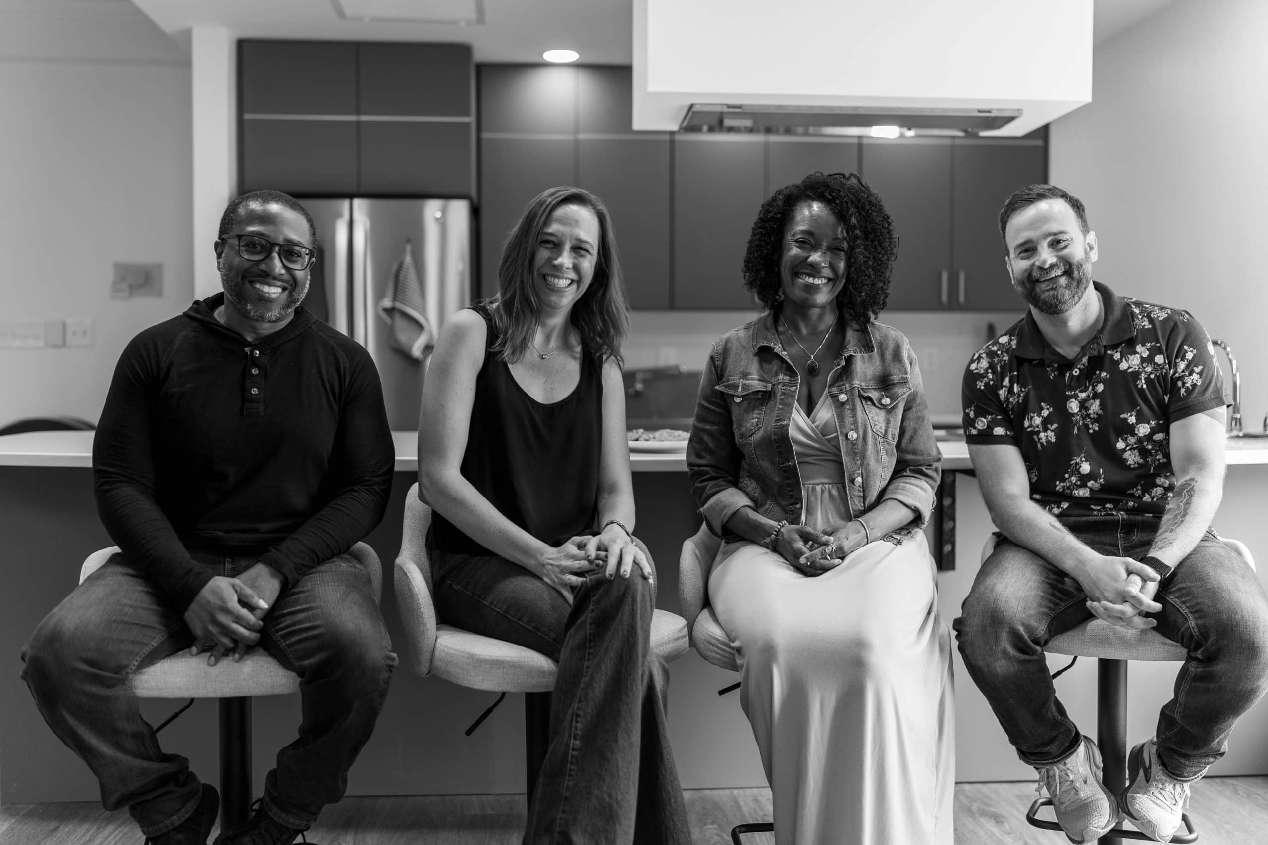 A Dose of Hope co-founders laughing while sitting on stools